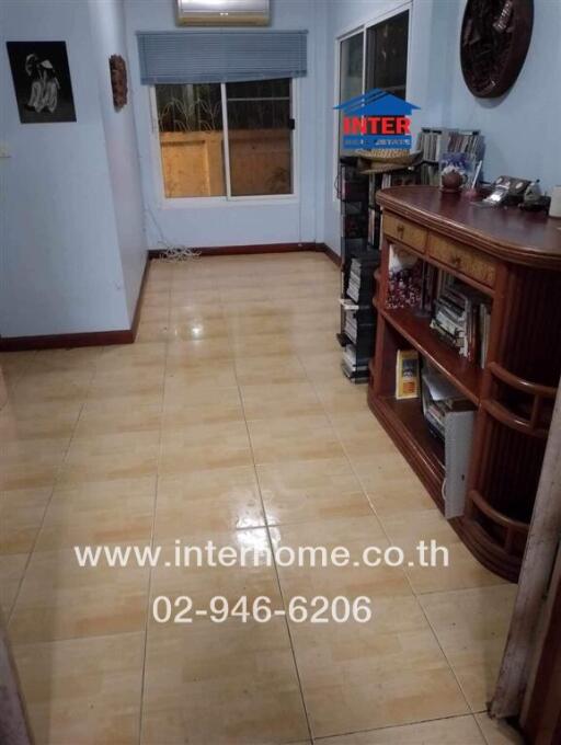 Spacious living room with tiled flooring and traditional wooden furniture