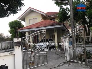 Two-story house with gate and carport