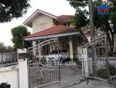 Two-story house with gate and carport