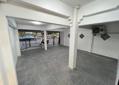 Spacious enclosed garage with modern tiling and secure gate
