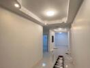 Modern hallway with high ceiling and recessed lighting