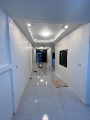 Modern white hallway with wall art and recessed lighting