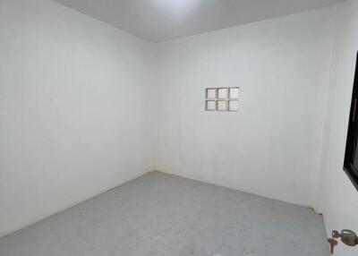 Empty small room with white walls and tiled floor