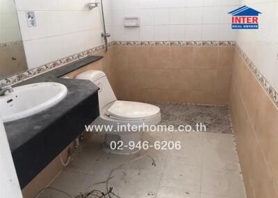 Spacious bathroom in need of cleaning and renovation, featuring a bathtub, sink, and toilet