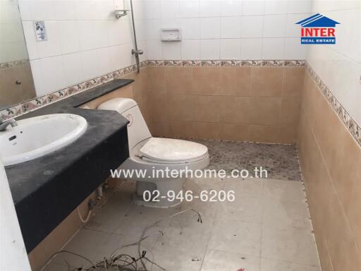 Spacious bathroom in need of cleaning and renovation, featuring a bathtub, sink, and toilet