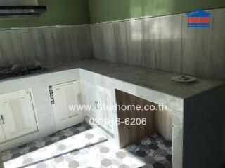 Spacious kitchen area with natural lighting and white cabinetry