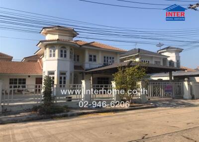 Spacious two-story house with gated entrance and landscaped garden