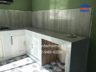 Spacious kitchen with green wall paint and wood paneling