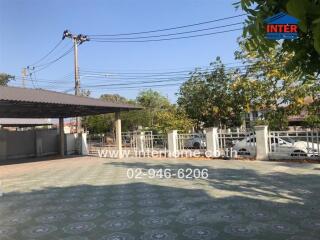 Spacious outdoor parking area with patterned floor and covered section