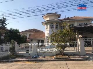 Exterior view of a residential building with a gated entrance