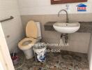 Compact bathroom with toilet and sink