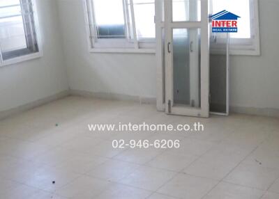 Spacious empty living room with large windows and balcony access