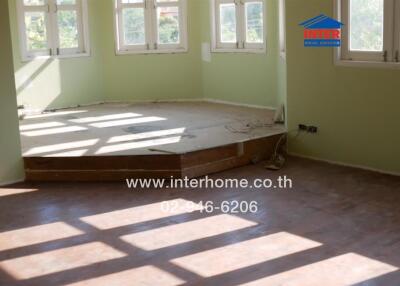 Spacious unfurnished bedroom with large windows and hardwood floors