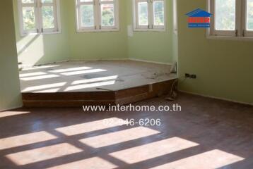 Spacious unfurnished bedroom with large windows and hardwood floors