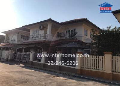 Spacious two-story house with balcony and gated entrance