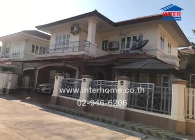 Spacious two-story residential home with balconies and carport