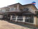 Spacious two-story residential home with balconies and carport