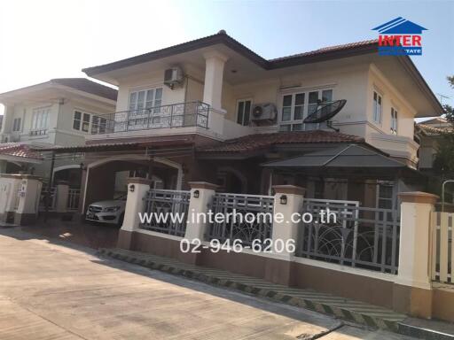 Spacious two-story residential home with balconies and carport