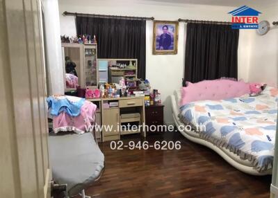 Spacious bedroom with large bed and ample storage