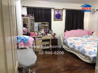 Spacious bedroom with large bed and ample storage