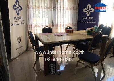 Spacious and well-lit dining room with a large table and comfortable seating