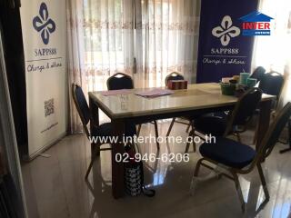 Spacious and well-lit dining room with a large table and comfortable seating