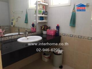 Well-equipped bathroom with modern amenities and storage space