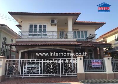 Spacious two-story house with balcony and secure front gate