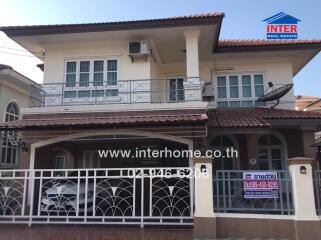 Spacious two-story house with balcony and secure gate