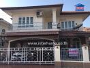 Spacious two-story house with balcony and secure gate