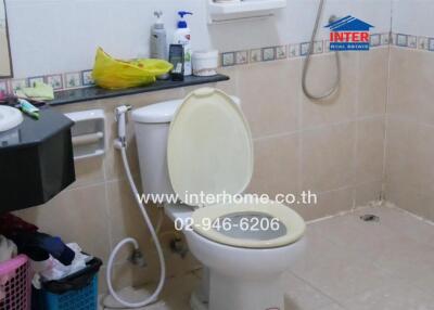 Bathroom with toilet and various personal items