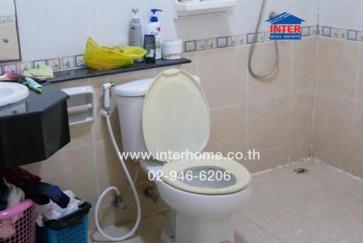 Bathroom with toilet and various personal items