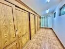 Spacious hallway with wooden wardrobe and tiled floor