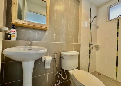 Modern bathroom with wall-mounted fixtures and neutral color scheme