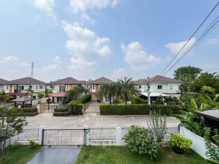 Suburban neighborhood with landscaped gardens and gated houses