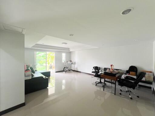 Spacious and bright living room with glossy floor and modern furniture