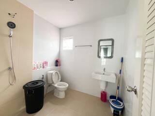 Modern bathroom with white tiles and essential fixtures