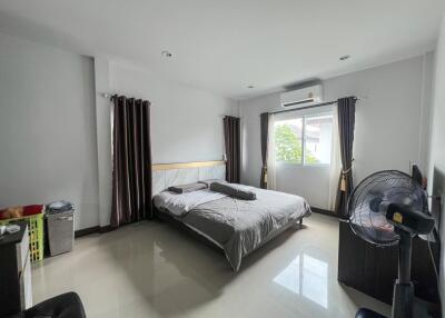 Spacious bedroom with modern decor and ample natural light