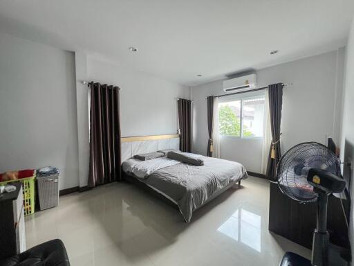 Spacious bedroom with modern decor and ample natural light