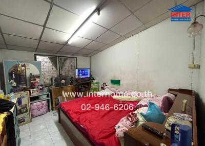 Spacious bedroom with multiple appliances and shelving