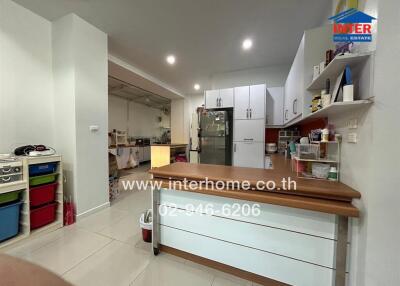 Spacious and well-lit modern kitchen with kitchen island and ample storage