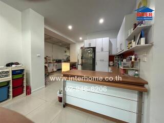 Spacious and well-lit modern kitchen with kitchen island and ample storage