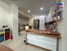 Spacious and well-lit modern kitchen with kitchen island and ample storage