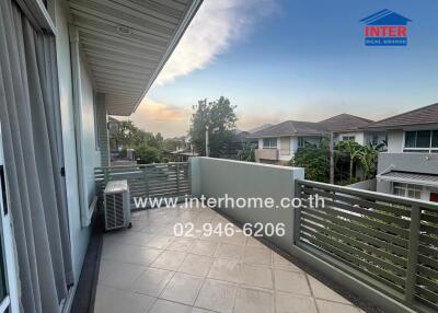 Spacious balcony with scenic sunset view in a residential area