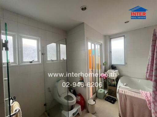 Bright bathroom with tub and window view