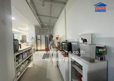 Well-equipped narrow kitchen with modern appliances and ample storage