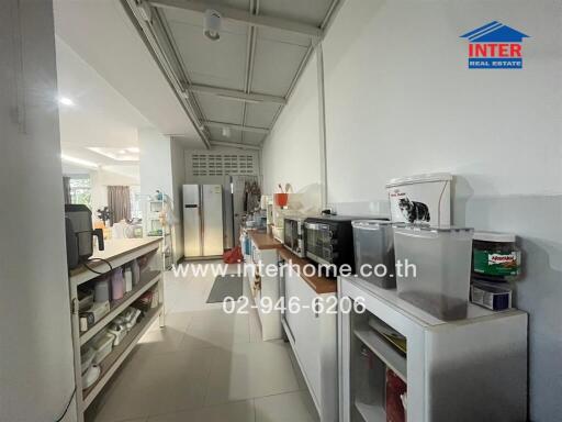 Well-equipped narrow kitchen with modern appliances and ample storage