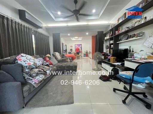 Spacious and modern living room with comfortable furnishings and home entertainment system