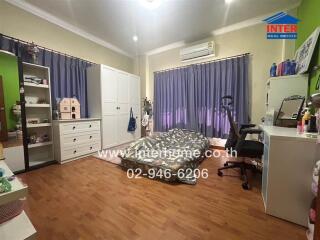 Spacious and well-furnished bedroom with ample storage