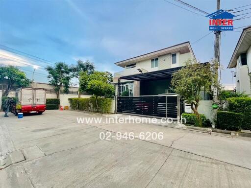 Suburban two-story house with visible garage and surrounding fence